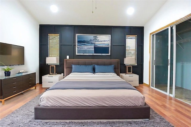 bedroom featuring a closet, wood finished floors, and recessed lighting