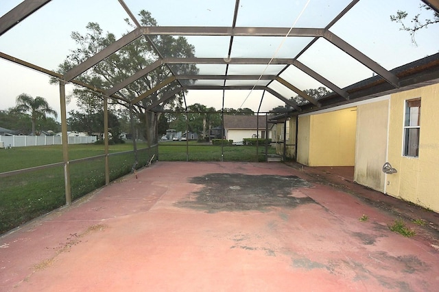 view of patio with a carport, a lanai, and fence