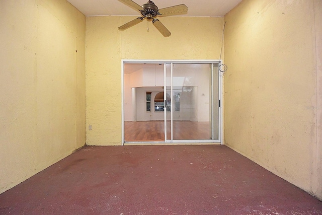 unfurnished room with ceiling fan and concrete floors