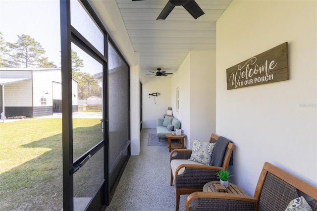 sunroom / solarium featuring ceiling fan