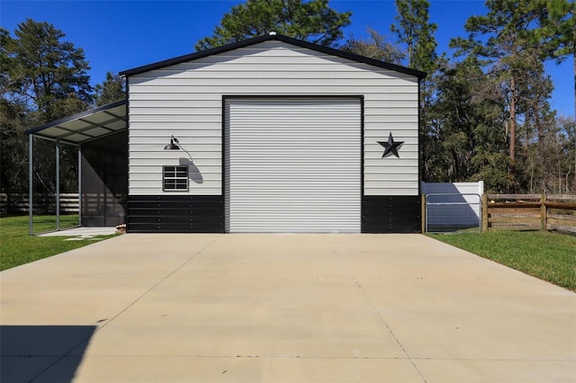 detached garage with driveway and fence