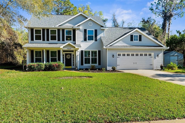 view of front facade with a front lawn, a garage, and driveway