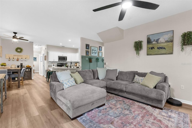 living area featuring recessed lighting, light wood-type flooring, and baseboards