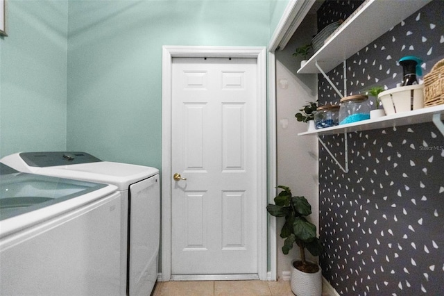 laundry area featuring tile patterned floors, separate washer and dryer, and laundry area