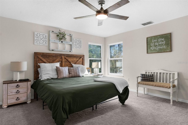 carpeted bedroom with a ceiling fan, baseboards, and visible vents