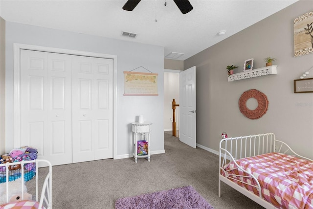 carpeted bedroom with a ceiling fan, baseboards, visible vents, and a closet