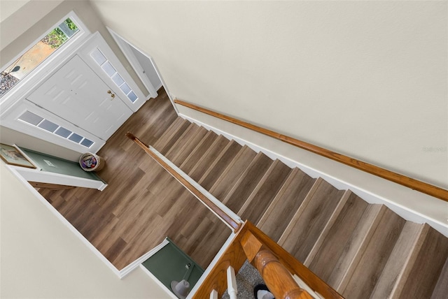 stairs featuring wood finished floors