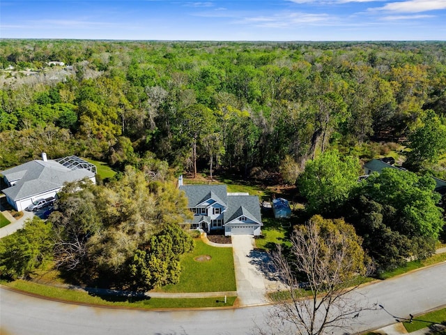 bird's eye view with a wooded view