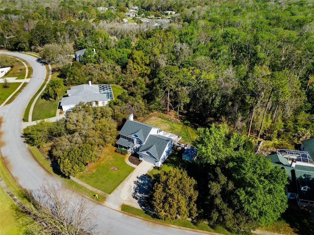 birds eye view of property featuring a view of trees