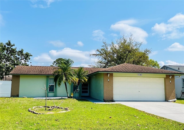 ranch-style house featuring brick siding, an attached garage, concrete driveway, and a front lawn