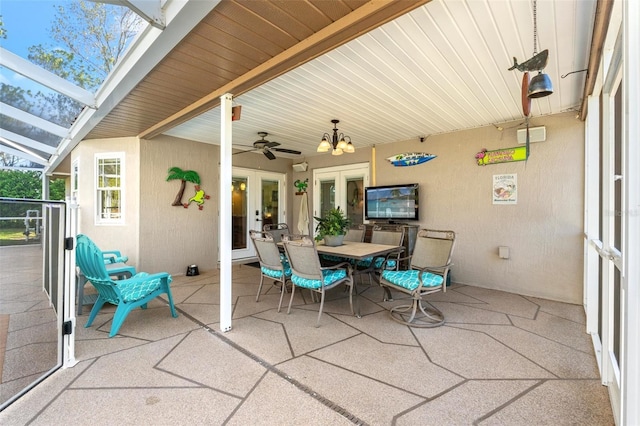 view of patio / terrace with french doors, ceiling fan, glass enclosure, and outdoor dining space