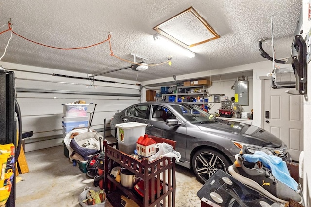 garage with electric panel and a garage door opener