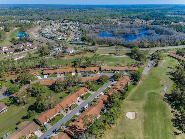 aerial view featuring a wooded view, golf course view, a residential view, and a water view