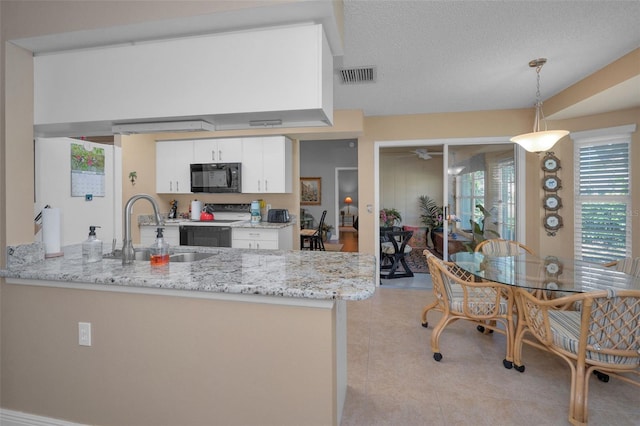 kitchen with visible vents, a sink, electric range oven, white cabinetry, and black microwave