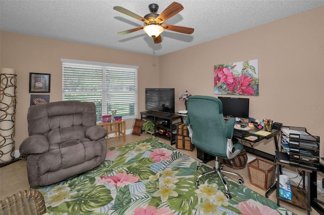 office space featuring a ceiling fan, baseboards, and a textured ceiling