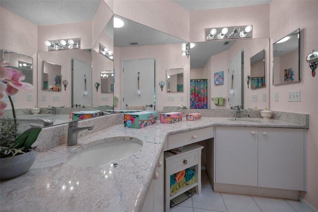 full bath featuring tile patterned floors, double vanity, a shower with shower curtain, and a sink