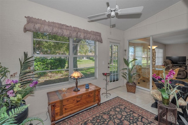 sunroom / solarium featuring lofted ceiling and ceiling fan