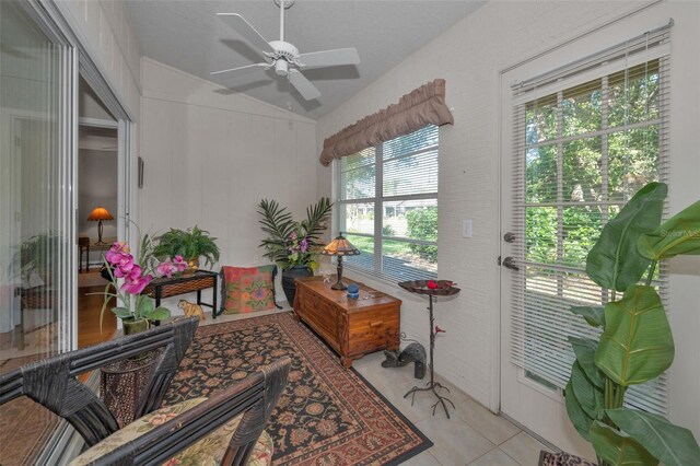 interior space with light tile patterned floors, ceiling fan, and vaulted ceiling