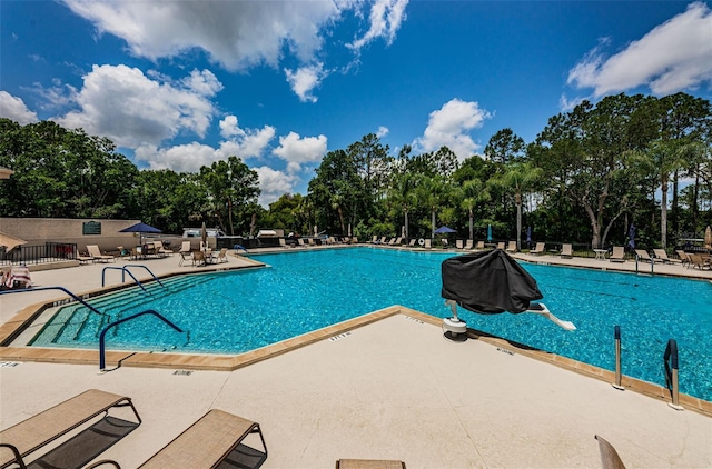 community pool with a patio area