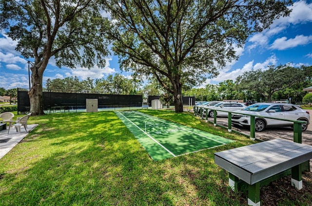 view of yard with shuffleboard and fence