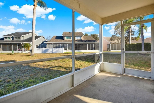 unfurnished sunroom featuring a residential view