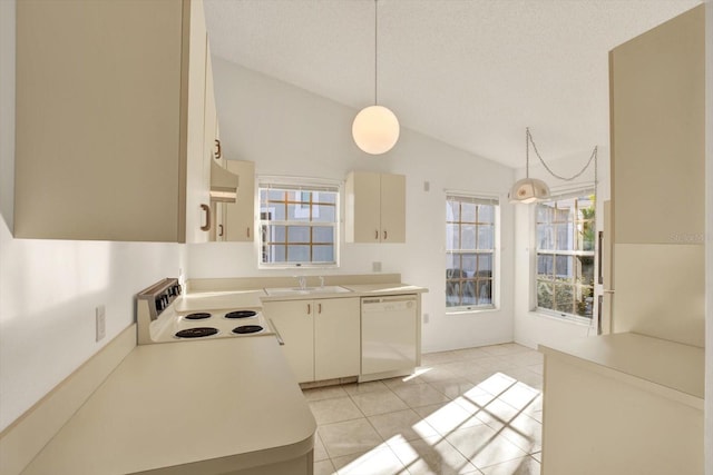 kitchen with white appliances, a sink, vaulted ceiling, light countertops, and pendant lighting