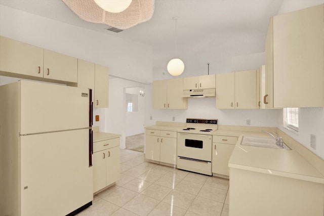 kitchen with a sink, under cabinet range hood, cream cabinets, white appliances, and light tile patterned floors