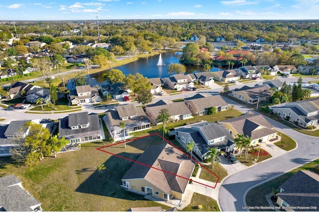 drone / aerial view featuring a residential view and a water view