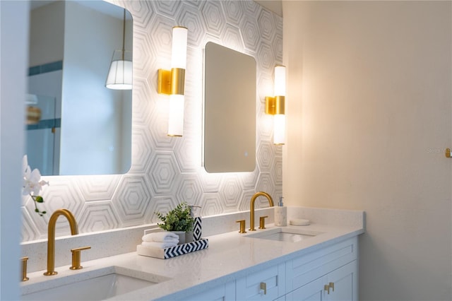 bathroom featuring double vanity, decorative backsplash, and a sink