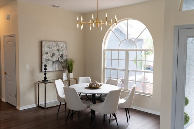 dining room with dark wood-style floors, a notable chandelier, visible vents, and baseboards