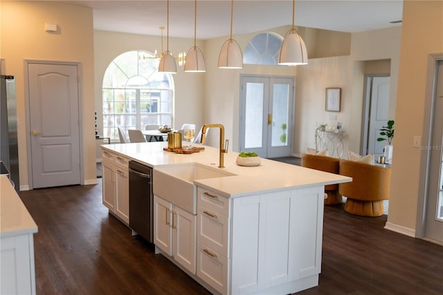 kitchen featuring dishwasher, dark wood-style flooring, freestanding refrigerator, light countertops, and a sink