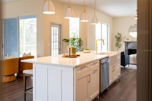 kitchen featuring dishwasher, dark wood-style floors, open floor plan, white cabinetry, and a sink