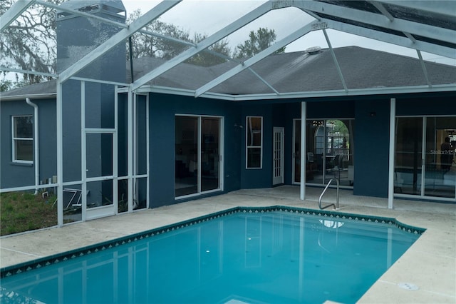 outdoor pool with a lanai and a patio