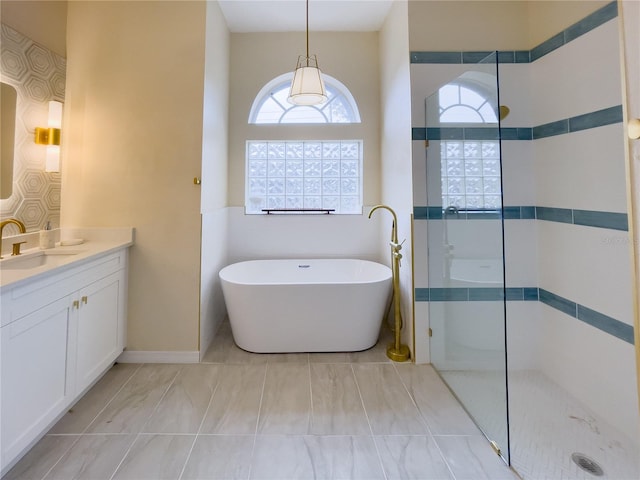 full bath with a walk in shower, a freestanding bath, and vanity