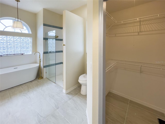 bathroom with a soaking tub, baseboards, a tile shower, and toilet