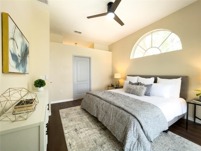 bedroom featuring dark wood-type flooring, visible vents, ceiling fan, and baseboards