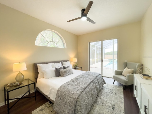 bedroom featuring access to exterior, multiple windows, and dark wood-type flooring