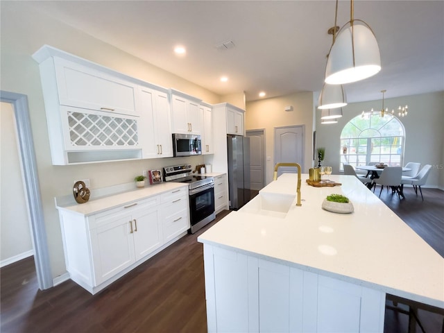 kitchen with stainless steel appliances, light countertops, a sink, and visible vents