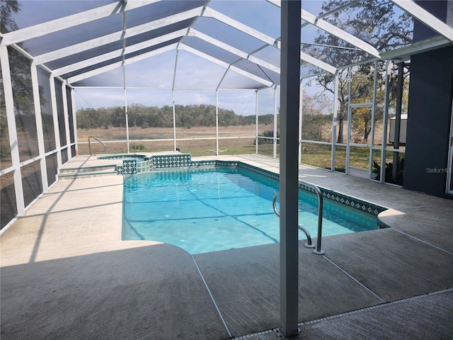 view of swimming pool with a lanai, a pool with connected hot tub, and a patio