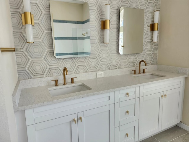 full bath featuring tile patterned flooring, a sink, and double vanity