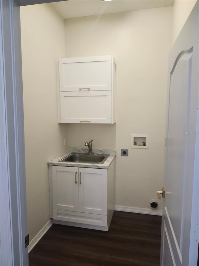 clothes washing area featuring hookup for an electric dryer, dark wood-type flooring, washer hookup, a sink, and baseboards