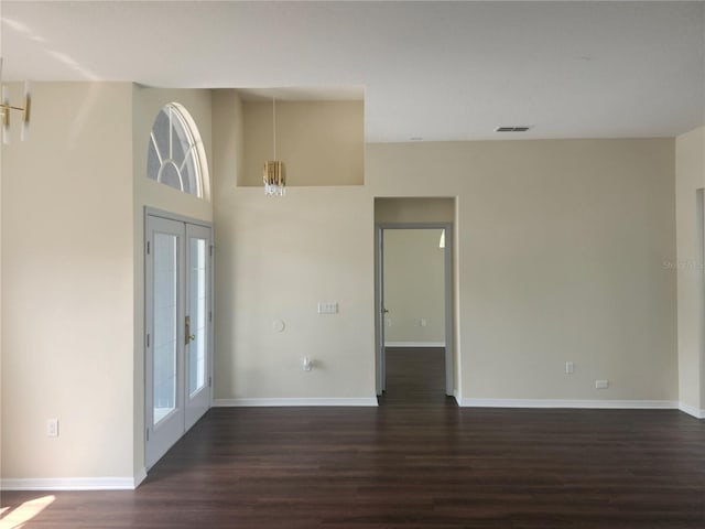 entryway featuring french doors, dark wood finished floors, visible vents, and baseboards