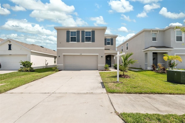 traditional-style home with stucco siding, a front lawn, a garage, and driveway