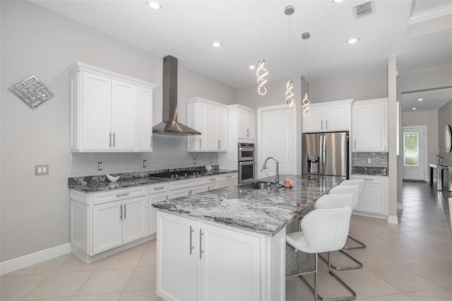 kitchen featuring light tile patterned floors, visible vents, wall chimney exhaust hood, stainless steel appliances, and white cabinetry