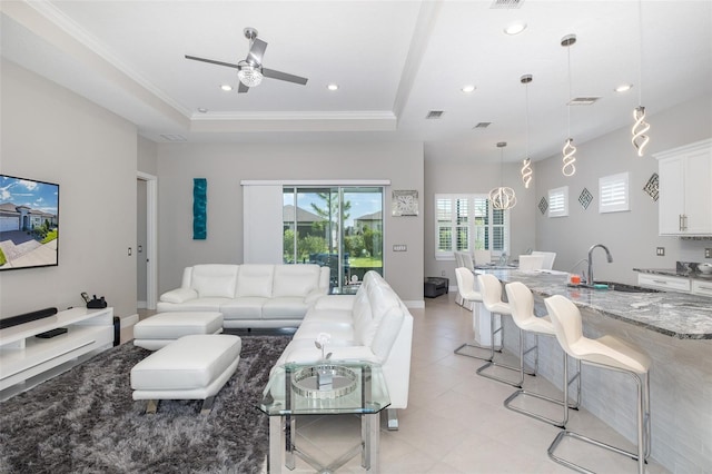 living area featuring ornamental molding, a tray ceiling, visible vents, and recessed lighting