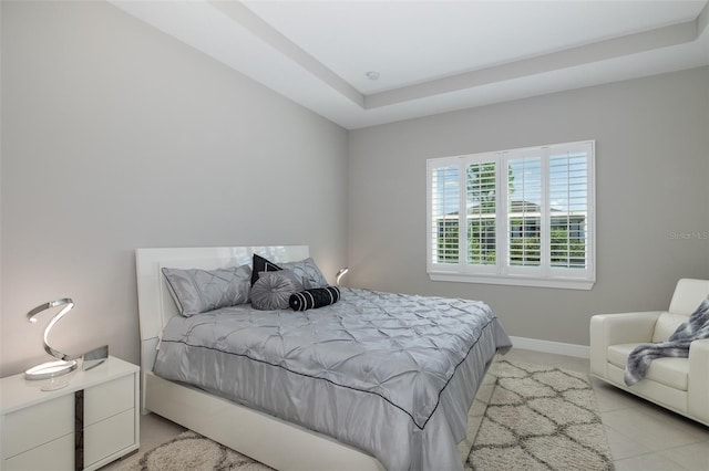 bedroom with baseboards and light tile patterned floors