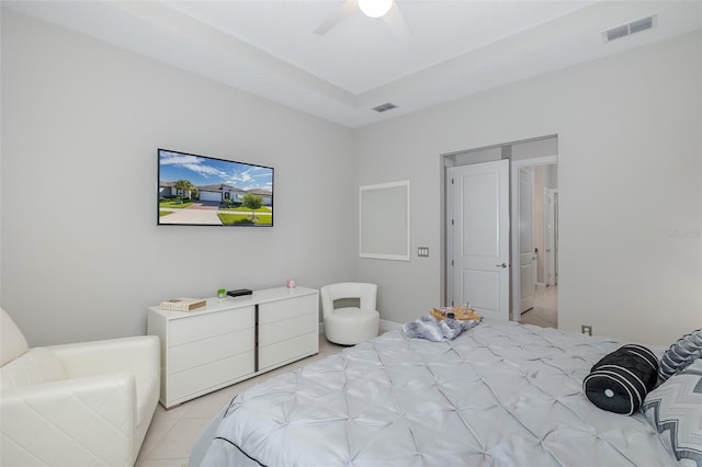 bedroom with light tile patterned floors, ceiling fan, and visible vents