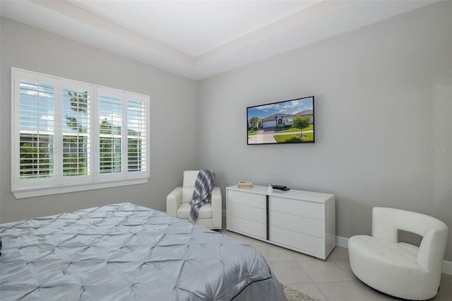 bedroom with light tile patterned flooring and baseboards