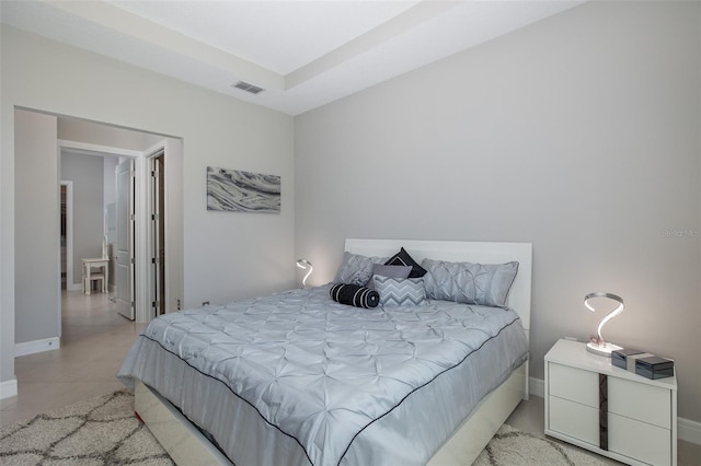 bedroom featuring light tile patterned floors, baseboards, and visible vents