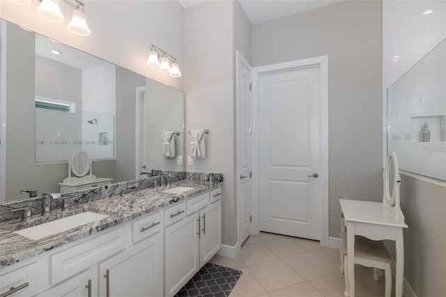 full bath with double vanity, tile patterned flooring, a walk in shower, and a sink